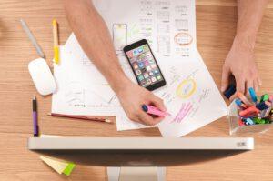 Office scene, seen from above a person highlighting a list of to do items